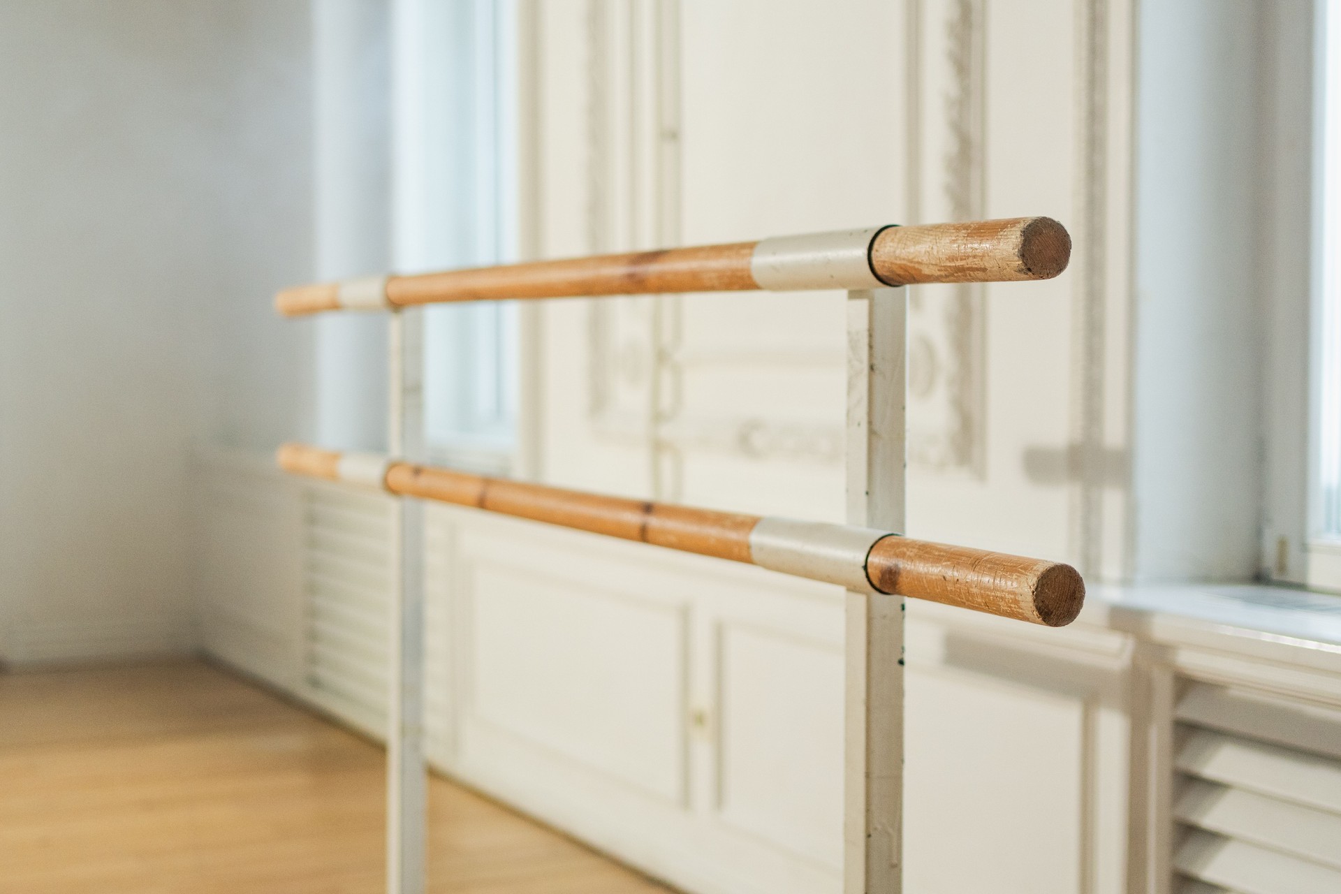 Empty ballet dance studio with barre. Professional ballet barre for stretching practicing dancing positions in dance school Dance hall ready for ballet class training. Ballet school.